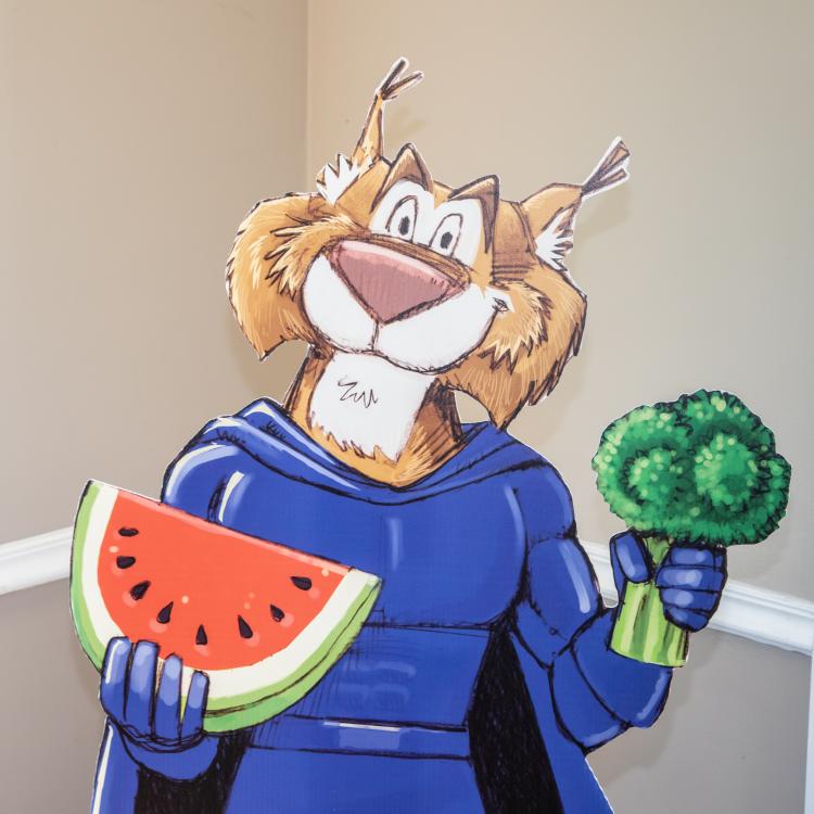  Wildcat Mascot holding piece of watermelon